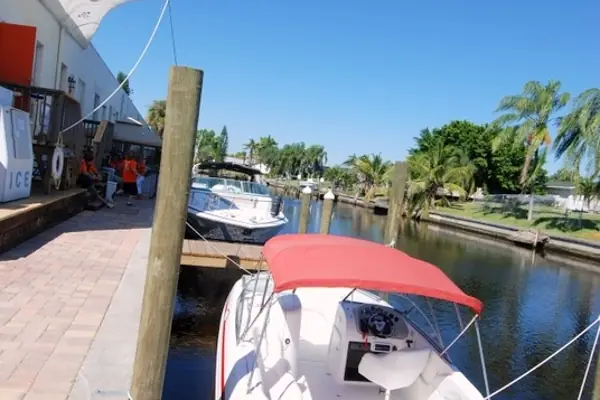 Brick walkway and boat slips along the marina canal in Cape Coral, FL